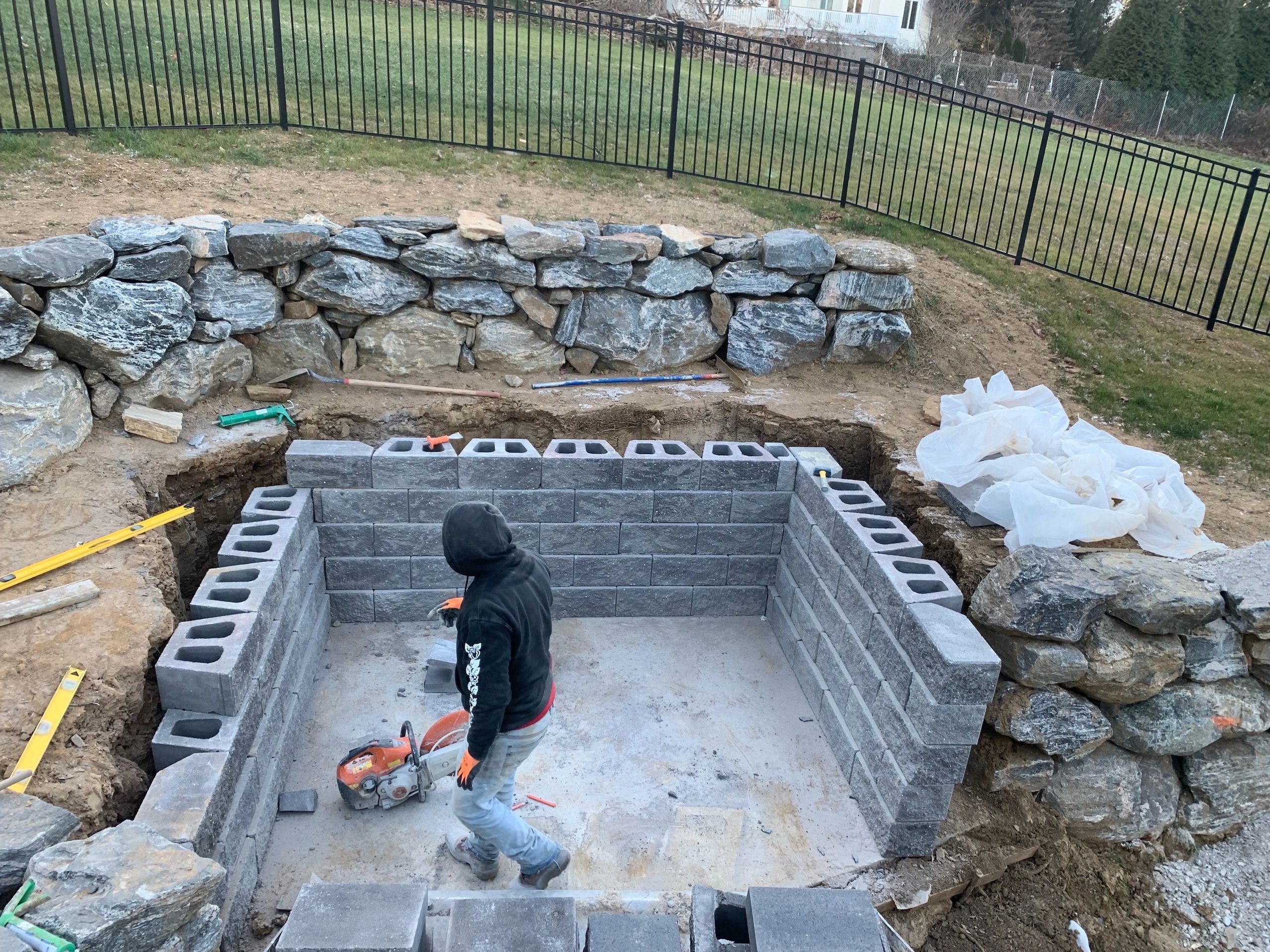 Residential backyard pool excavation in progress