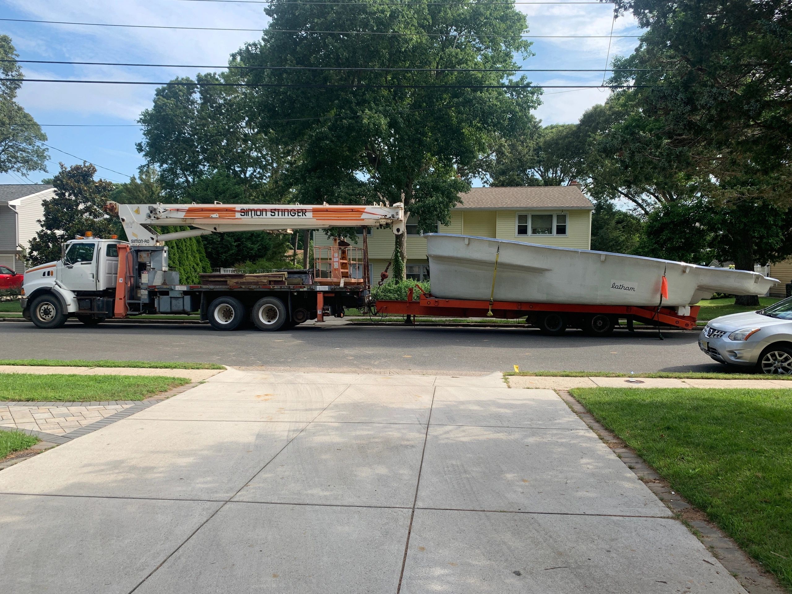Kenworth flatbed truck hauling a fiberglass pool — oversize load