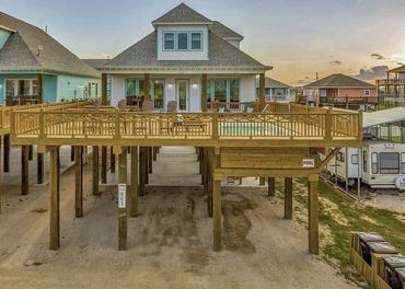 Beachfront elevated home with wraparound wooden deck